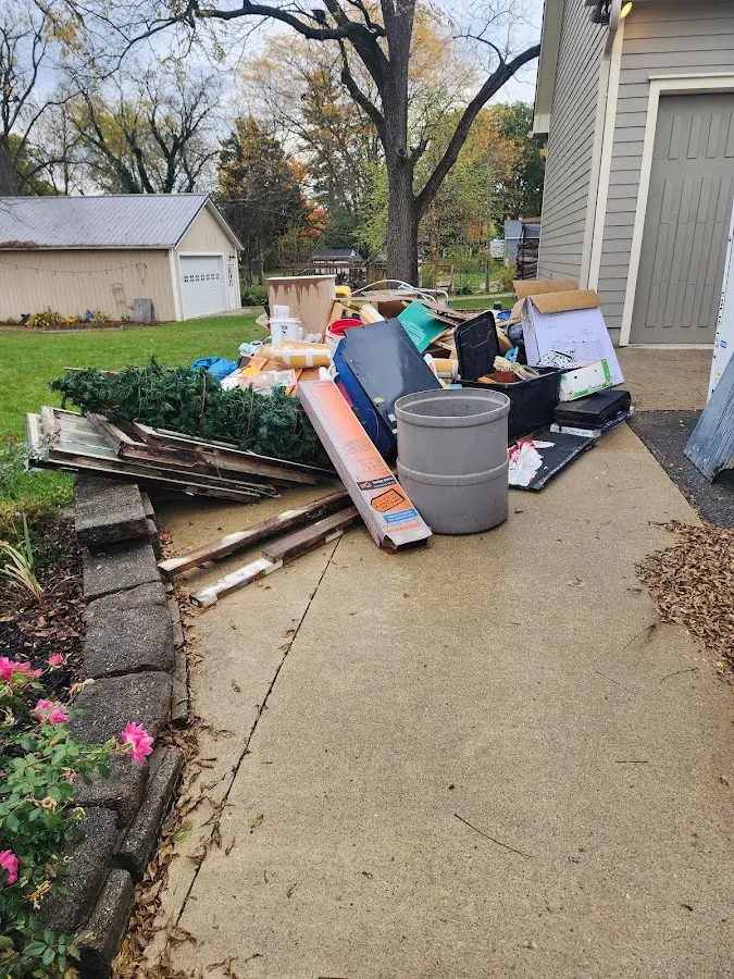 Dumpster being loaded with debris for Commercial Dumpster Rental in St. Anthony